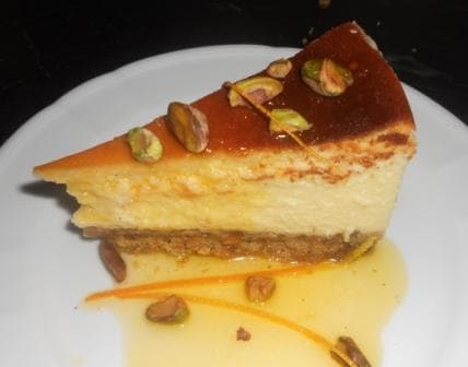 Kulfi-Inspired Cheesecake: White Chocolate, Cardamom and Pistachio, with Orange Syrup