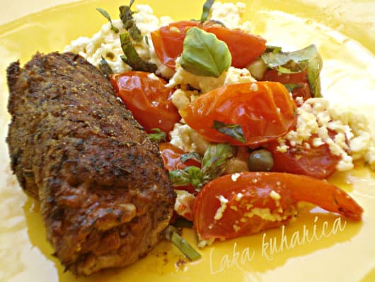 Steaks with pesto, tomatoes and feta cheese