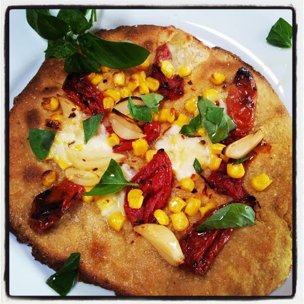 fresh corn, roasted tomato & pickled garlic pizza with cornmeal crust