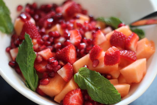 Minty Cantaloupe, Strawberry and Pomegranate Salad with Honey Lemon Dressing