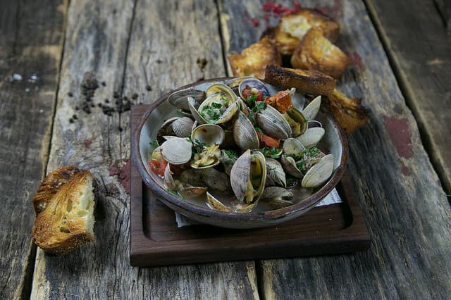 Roasted Clams with Sausage, Tomatoes and Fregola  