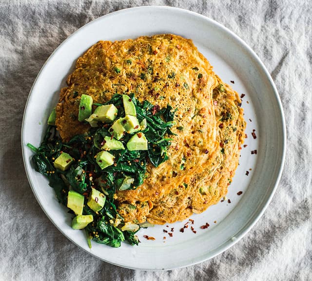 Pudla: Indian chickpea pancakes with peas, cilantro, and sauteed spinach