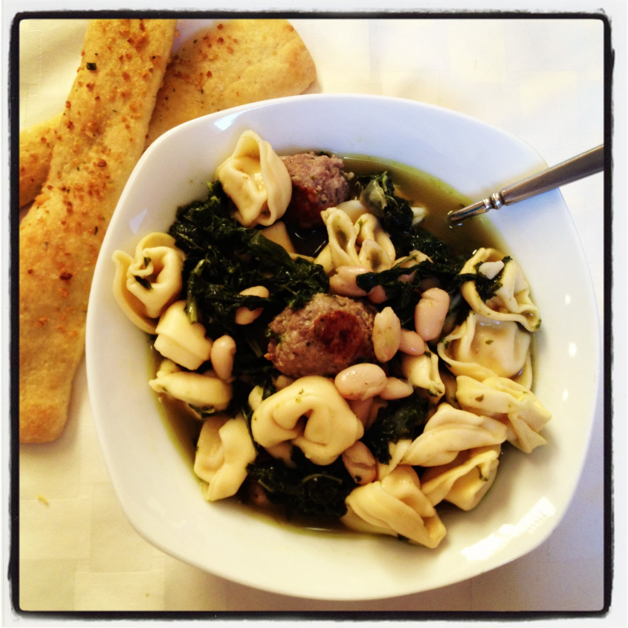 Tortellini with Kale, Cannellini Beans and Sausage in Broth