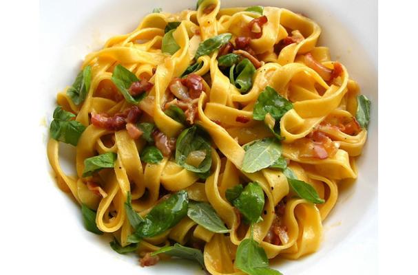 tagliatelle alla carbonara garnished with fresh basil